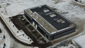 Distant drone shot of a solar array on top of a building