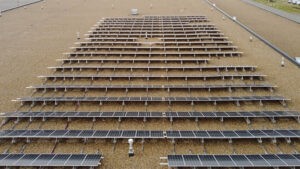 Closer drone shot of a solar array on top of a building
